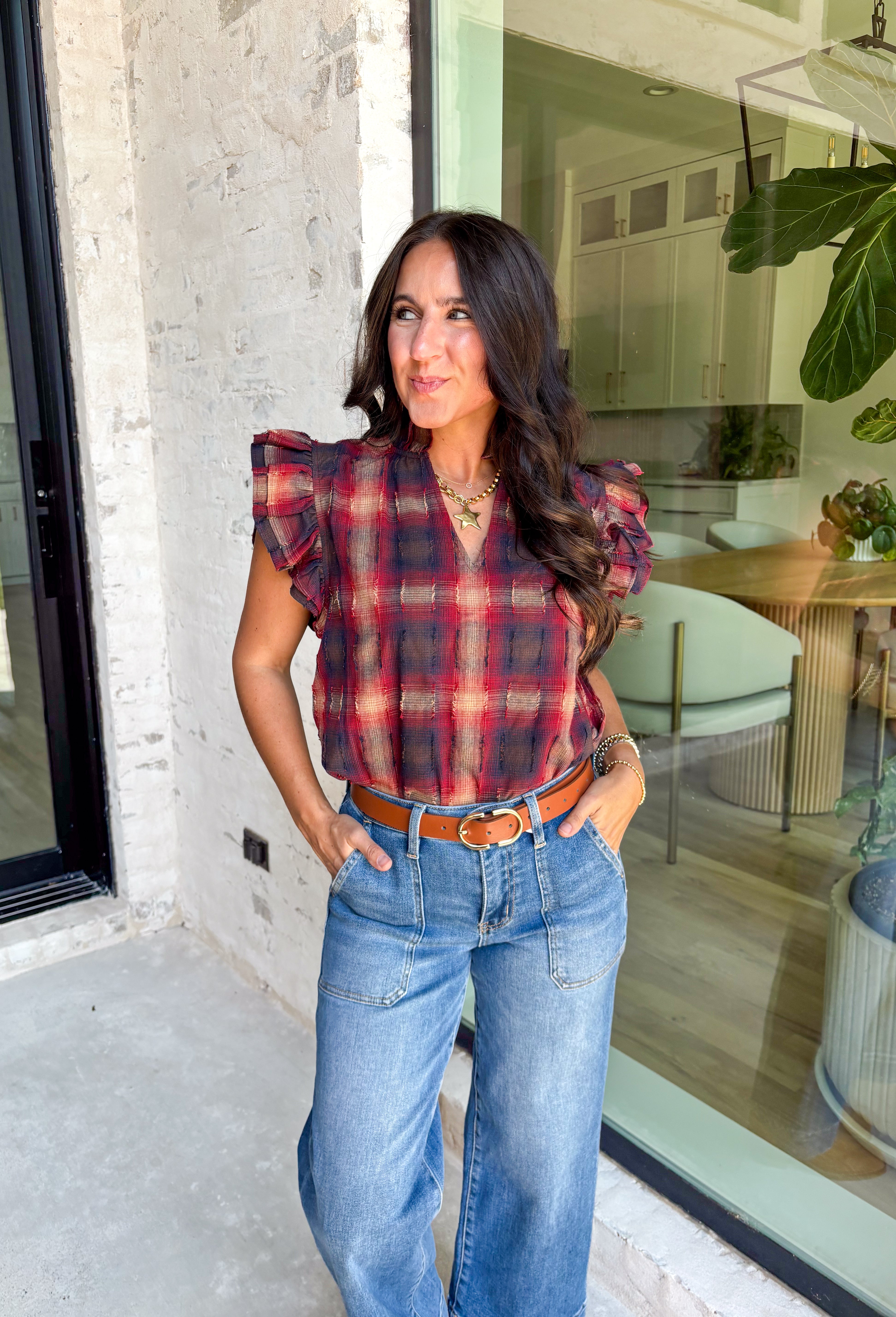 Fall plaid gets a playful refresh with this textured blouse from THML. Designed in rich shades of burgundy, navy, and light tan, it’s finished with ruffle sleeves and a ruffle neckline that add a feminine twist to a timeless pattern. The textured fabric gives it extra depth, making this top perfect for pairing with denim, skirts, or layering under cardigans for the season.