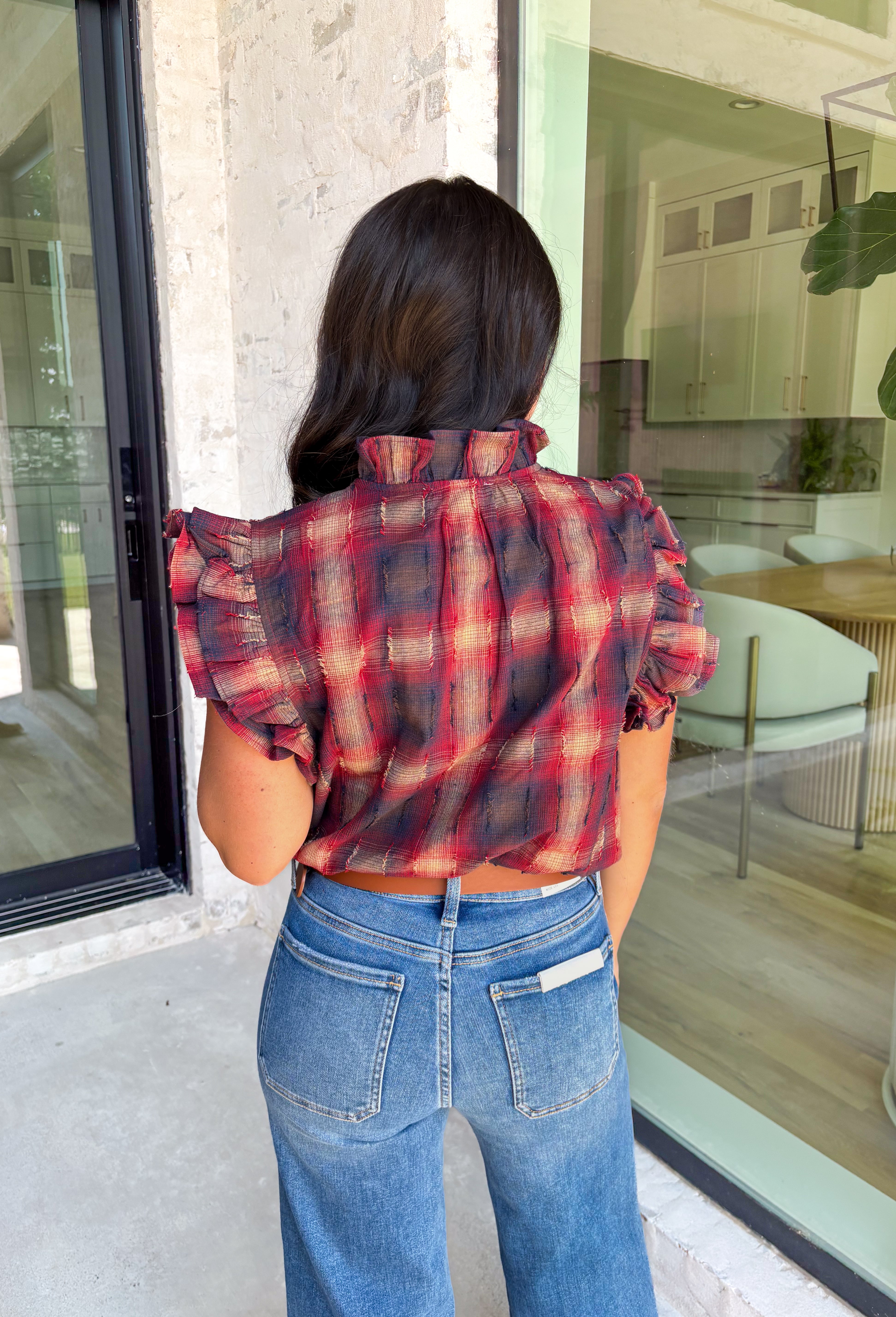 Fall plaid gets a playful refresh with this textured blouse from THML. Designed in rich shades of burgundy, navy, and light tan, it’s finished with ruffle sleeves and a ruffle neckline that add a feminine twist to a timeless pattern. The textured fabric gives it extra depth, making this top perfect for pairing with denim, skirts, or layering under cardigans for the season.