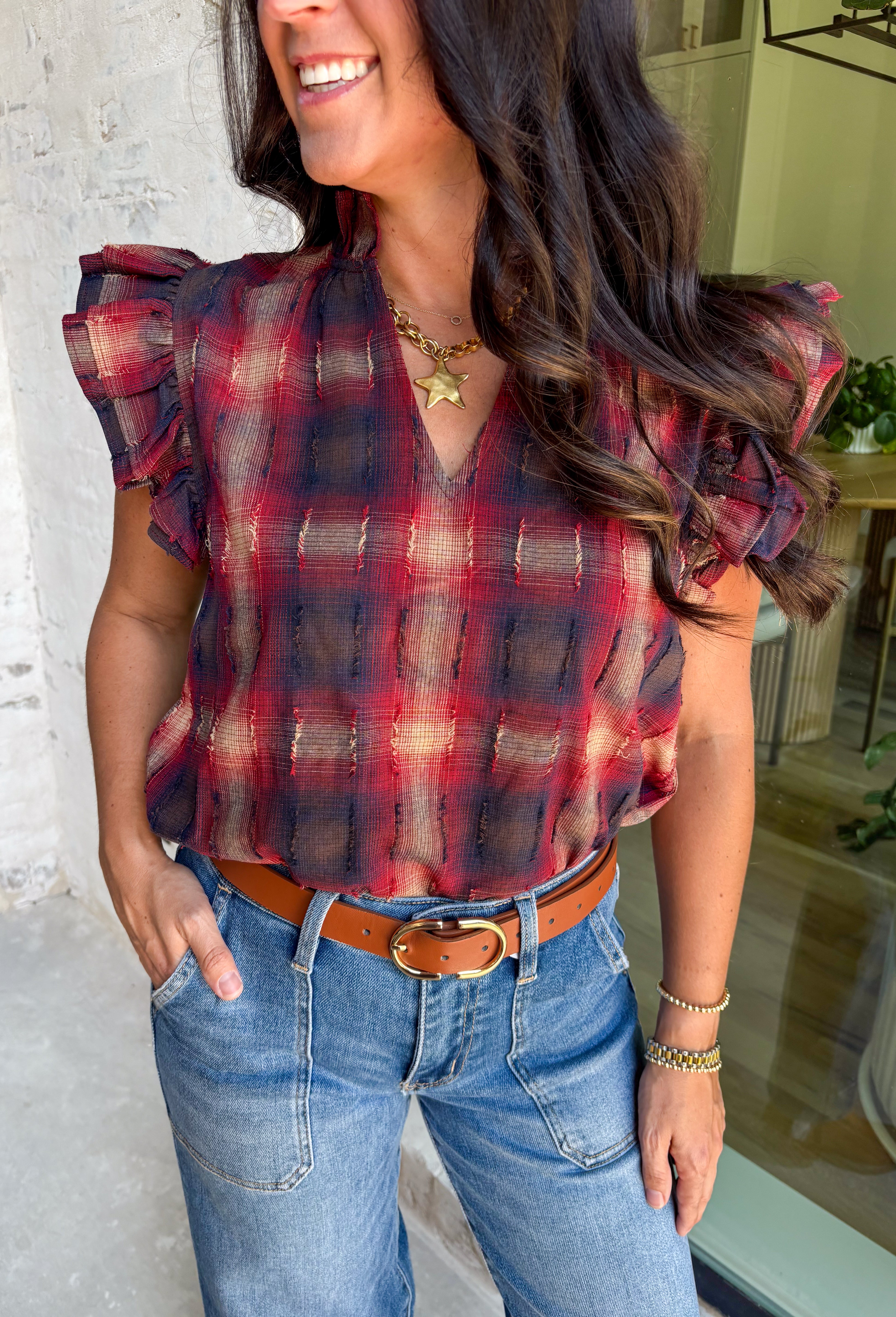 Fall plaid gets a playful refresh with this textured blouse from THML. Designed in rich shades of burgundy, navy, and light tan, it’s finished with ruffle sleeves and a ruffle neckline that add a feminine twist to a timeless pattern. The textured fabric gives it extra depth, making this top perfect for pairing with denim, skirts, or layering under cardigans for the season.