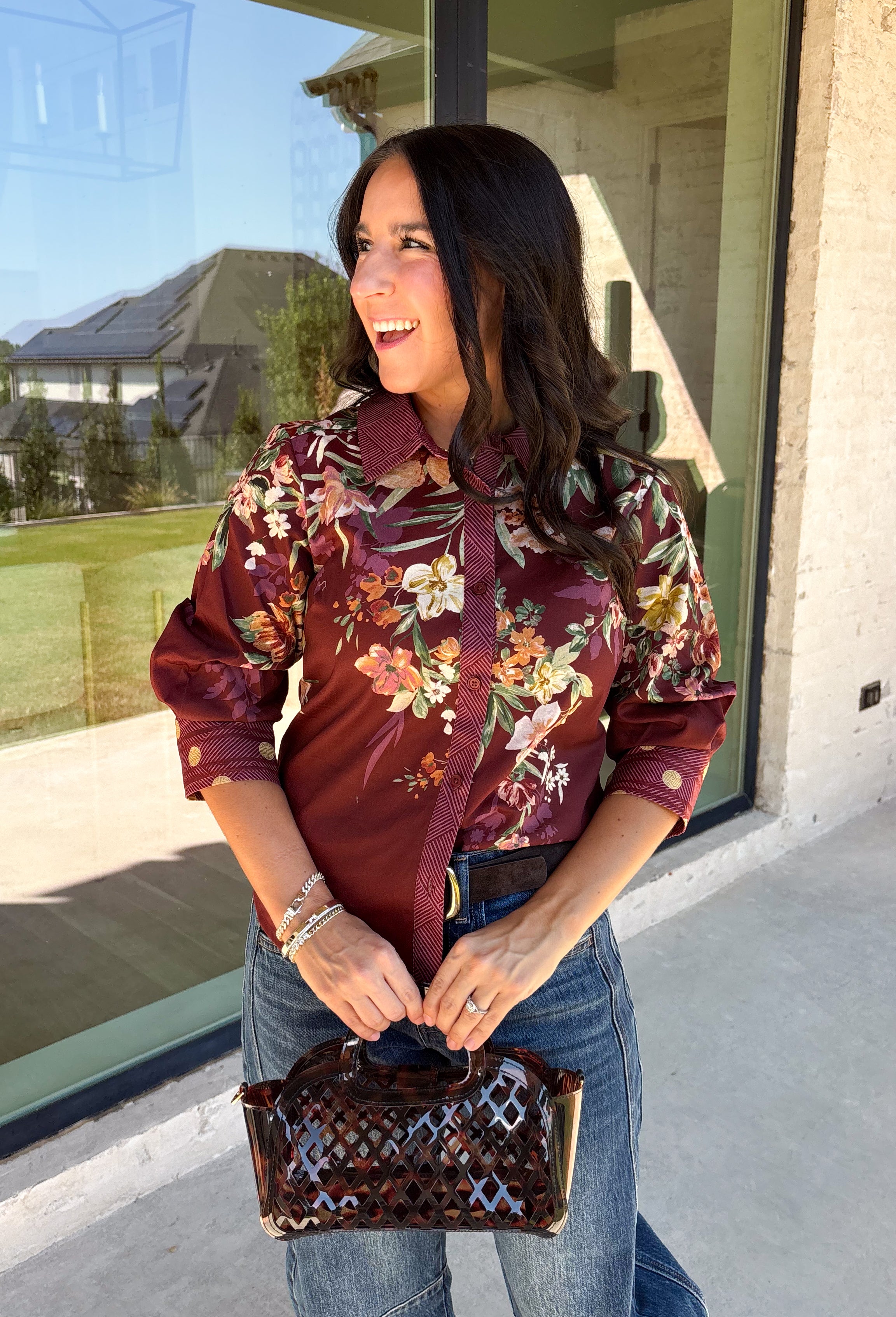 Bring a little fall color into your workweek with this burgundy floral blouse from Current Air. The rich burgundy background is covered in a seasonal floral print, while contrasting stripe trim throughout gives the design a fresh, eye-catching finish. A collared neckline and button-down front keep the look classic and work-ready, with ¾ length sleeves making it an easy choice for transitioning into cooler days. 