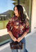 Bring a little fall color into your workweek with this burgundy floral blouse from Current Air. The rich burgundy background is covered in a seasonal floral print, while contrasting stripe trim throughout gives the design a fresh, eye-catching finish. A collared neckline and button-down front keep the look classic and work-ready, with ¾ length sleeves making it an easy choice for transitioning into cooler days. 