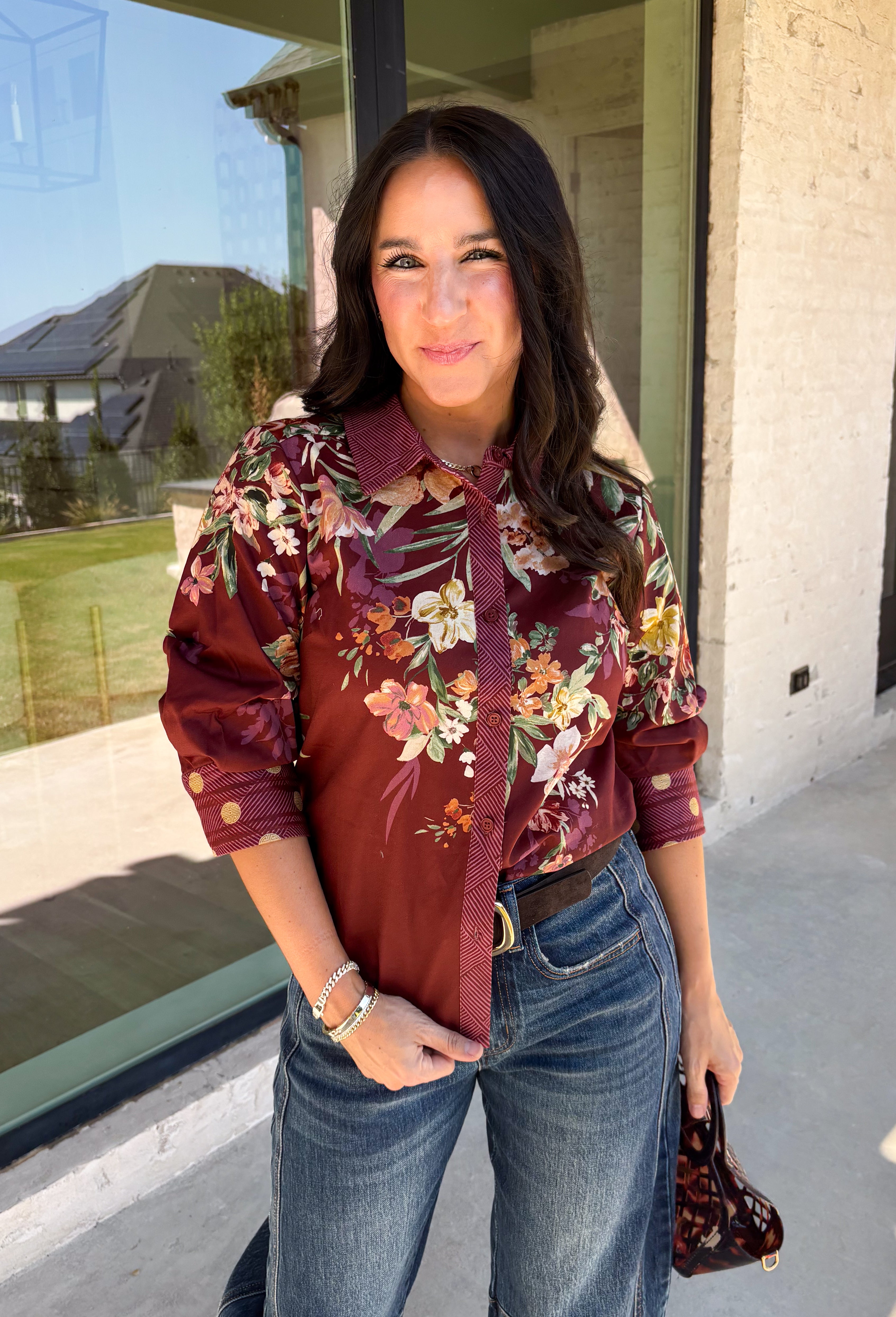 Bring a little fall color into your workweek with this burgundy floral blouse from Current Air. The rich burgundy background is covered in a seasonal floral print, while contrasting stripe trim throughout gives the design a fresh, eye-catching finish. A collared neckline and button-down front keep the look classic and work-ready, with ¾ length sleeves making it an easy choice for transitioning into cooler days. 