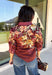 Bring a little fall color into your workweek with this burgundy floral blouse from Current Air. The rich burgundy background is covered in a seasonal floral print, while contrasting stripe trim throughout gives the design a fresh, eye-catching finish. A collared neckline and button-down front keep the look classic and work-ready, with ¾ length sleeves making it an easy choice for transitioning into cooler days. 