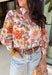 This off-white long sleeve button down top is the definition of effortless spring style. Covered in a beautiful mix of rust, pink, blue, purple, and green florals, it feels fresh, colorful, and ready for sunny days ahead. The classic button-front design and lightweight cotton fabric keep it easy and breathable, while the vibrant print adds that fun pop your wardrobe has been waiting for. It’s polished enough for work and relaxed enough for weekend plans—truly a wear-anywhere favorite.