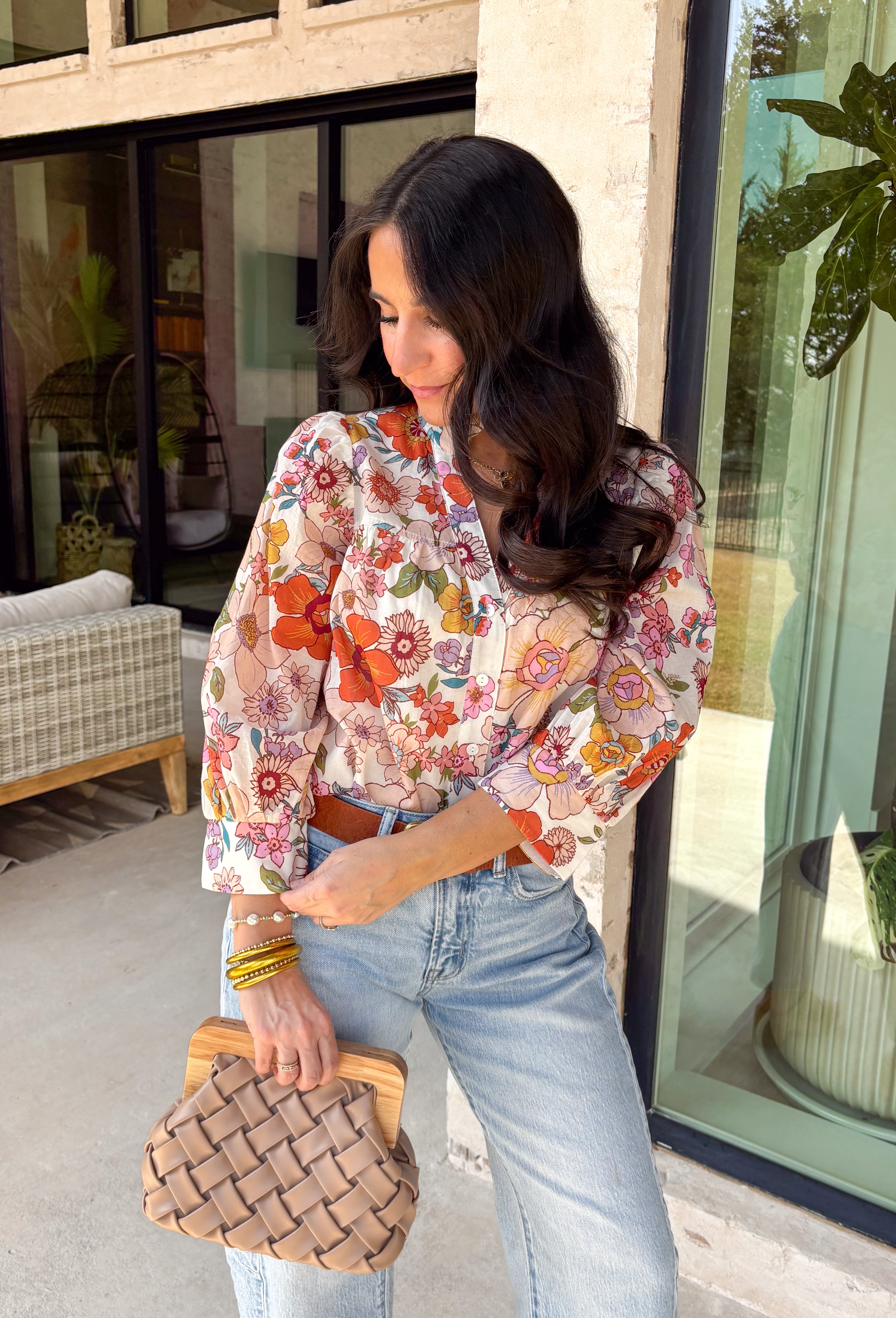 This off-white long sleeve button down top is the definition of effortless spring style. Covered in a beautiful mix of rust, pink, blue, purple, and green florals, it feels fresh, colorful, and ready for sunny days ahead. The classic button-front design and lightweight cotton fabric keep it easy and breathable, while the vibrant print adds that fun pop your wardrobe has been waiting for. It’s polished enough for work and relaxed enough for weekend plans—truly a wear-anywhere favorite.