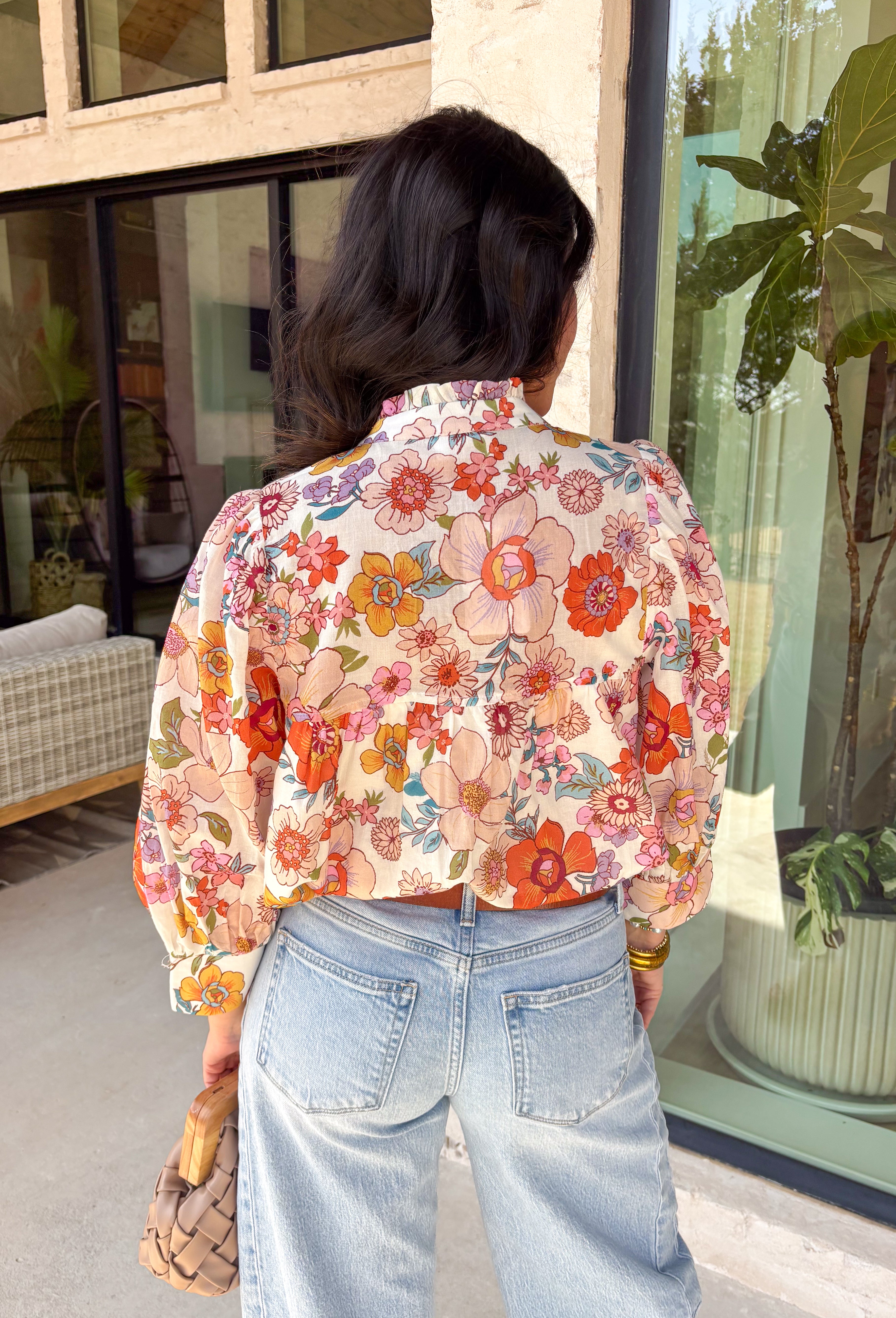 This off-white long sleeve button down top is the definition of effortless spring style. Covered in a beautiful mix of rust, pink, blue, purple, and green florals, it feels fresh, colorful, and ready for sunny days ahead. The classic button-front design and lightweight cotton fabric keep it easy and breathable, while the vibrant print adds that fun pop your wardrobe has been waiting for. It’s polished enough for work and relaxed enough for weekend plans—truly a wear-anywhere favorite.