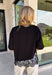 Elevate your everyday fall wardrobe with this effortlessly chic knit top! Crafted from a soft, comfortable knit, this versatile piece is finished with a beautiful scalloped lace hem that adds just the right amount of feminine detail. The classic black color makes it easy to style with everything from denim to printed bottoms, while the trendy silhouette transitions seamlessly from the office to dinner plans. 