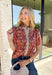 Add a touch of feminine charm to your everyday wardrobe with this beautifully detailed top from Entro. Featuring a rich brown backdrop with a pink floral print, this timeless blouse is full of thoughtful details you'll love. The ruffled neckline creates an effortlessly polished look, while the brown gingham contrast trim adds the perfect pop of classic charm. 