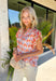 This abstract floral top is bringing all the bold, colorful energy your summer wardrobe needs! With a neutral base and vibrant pops of pink, coral, purple, red, white, and green, it’s the perfect statement piece that still feels easy to style. The contrasting floral print on the sleeves and neckline adds a fun, unexpected twist, while the ruffle sleeves and v-neckline keep it feminine and flattering. Lightweight and breathable, it’s perfect for warm days when you want to stand out without trying too hard. 