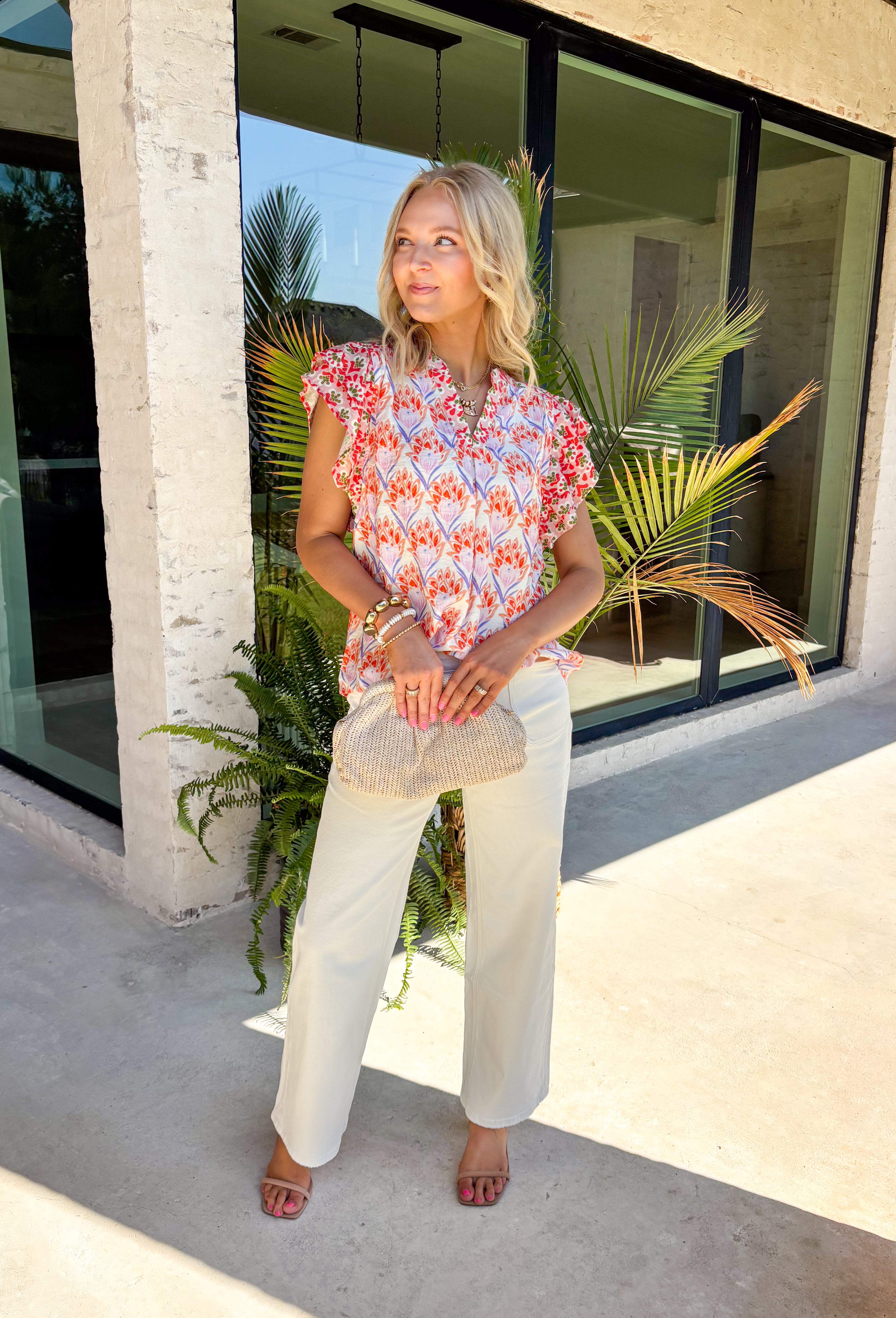 This abstract floral top is bringing all the bold, colorful energy your summer wardrobe needs! With a neutral base and vibrant pops of pink, coral, purple, red, white, and green, it’s the perfect statement piece that still feels easy to style. The contrasting floral print on the sleeves and neckline adds a fun, unexpected twist, while the ruffle sleeves and v-neckline keep it feminine and flattering. Lightweight and breathable, it’s perfect for warm days when you want to stand out without trying too hard. 