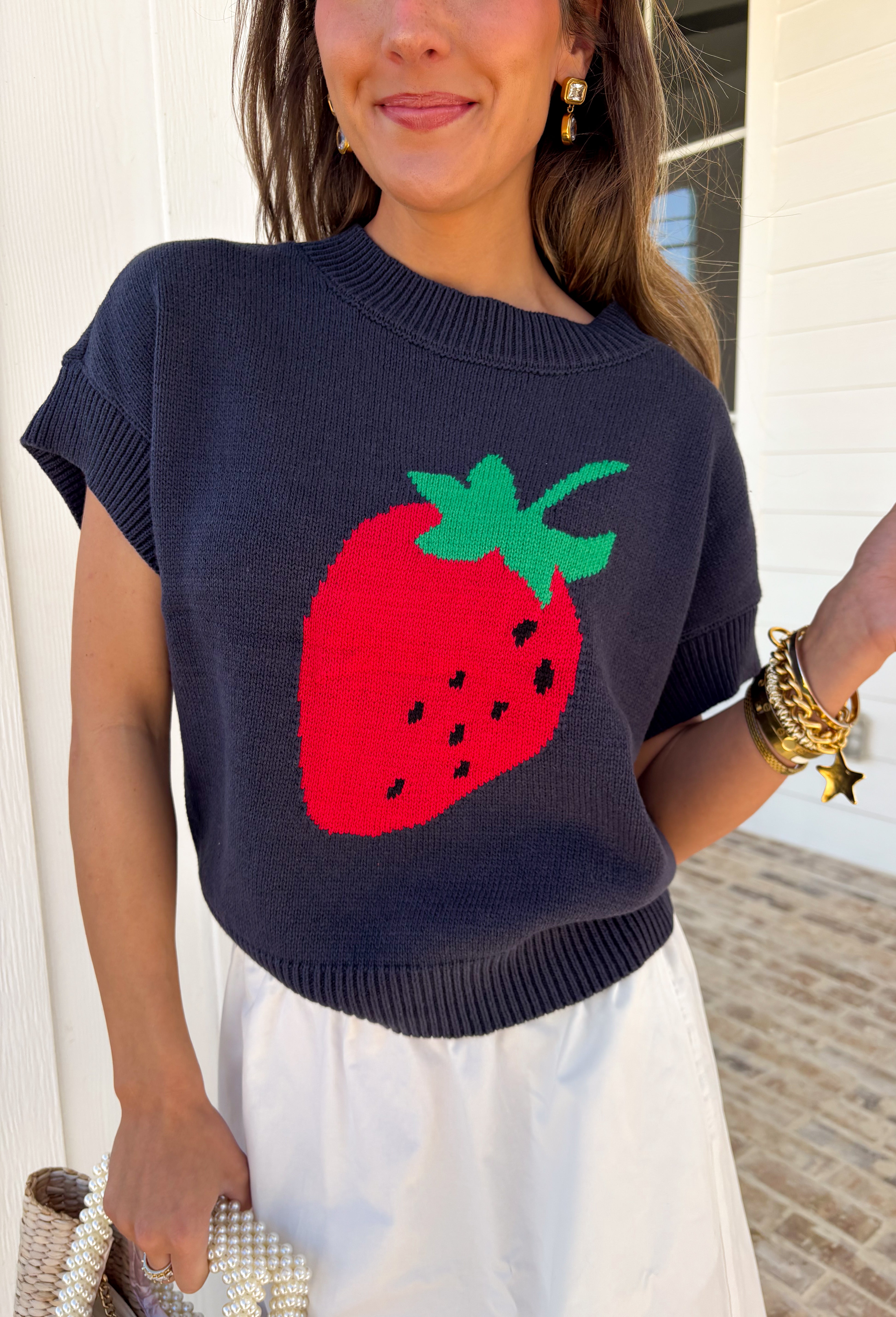 Sweet, playful, and full of charm! This navy short sleeve sweater features the cutest strawberry knit design that instantly adds a fun, fresh touch to your look. The rich navy background makes the strawberries pop, giving it that perfect mix of classic and playful style. Designed with a ribbed neckline, sleeves, and hem, this sweater offers a comfortable and flattering fit that’s easy to wear all day long. 