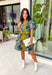 Bring timeless charm to your fall wardrobe with this beautifully detailed floral dress. Designed in a rich olive green with a stunning blue and navy floral print, this cotton dress is the perfect blend of classic and feminine. The flattering v-neckline, button-front design, and self-tie waist create a silhouette that's effortlessly polished, while the gathered back yoke adds a soft, flowy fit you'll love.