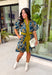 Bring timeless charm to your fall wardrobe with this beautifully detailed floral dress. Designed in a rich olive green with a stunning blue and navy floral print, this cotton dress is the perfect blend of classic and feminine. The flattering v-neckline, button-front design, and self-tie waist create a silhouette that's effortlessly polished, while the gathered back yoke adds a soft, flowy fit you'll love.