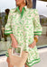 Fresh, timeless, and perfect for spring, this off-white dress by Entro is an easy favorite for sunny days ahead. Featuring a light green floral print throughout, it has a soft, feminine look that feels effortlessly wearable. Dark green trim along the sleeves and hem adds a polished contrast, while the front button details give it a classic touch. Finished with side pockets and a full lining, this dress is comfortable, flattering, and ready for everything from brunch to spring events.