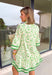 Fresh, timeless, and perfect for spring, this off-white dress by Entro is an easy favorite for sunny days ahead. Featuring a light green floral print throughout, it has a soft, feminine look that feels effortlessly wearable. Dark green trim along the sleeves and hem adds a polished contrast, while the front button details give it a classic touch. Finished with side pockets and a full lining, this dress is comfortable, flattering, and ready for everything from brunch to spring events.