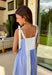 Nothing says easy summer style like blue and white stripes! This sleeveless midi dress features a mix of stripe prints in varying shades of blue with white for a fresh, playful take on a classic pattern. The adjustable tie strap sleeves add a sweet, feminine touch while letting you customize the fit. Designed with a button front and flattering smocking along the back, this dress blends structure with comfort beautifully. 