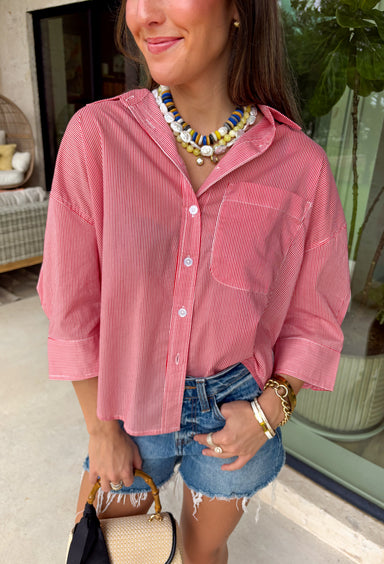 This red and white stripe button down top is a summer classic with a patriotic twist! The timeless stripe print makes it easy to style, while the white stripe detail along the back adds an unexpected touch that sets it apart. Designed with a collared neckline, front pocket, and easy button down silhouette, it’s the perfect piece for everything from backyard BBQs to fireworks and holiday weekends. Made from breathable cotton, it’s lightweight, comfortable, and ready for all your summer plans. 