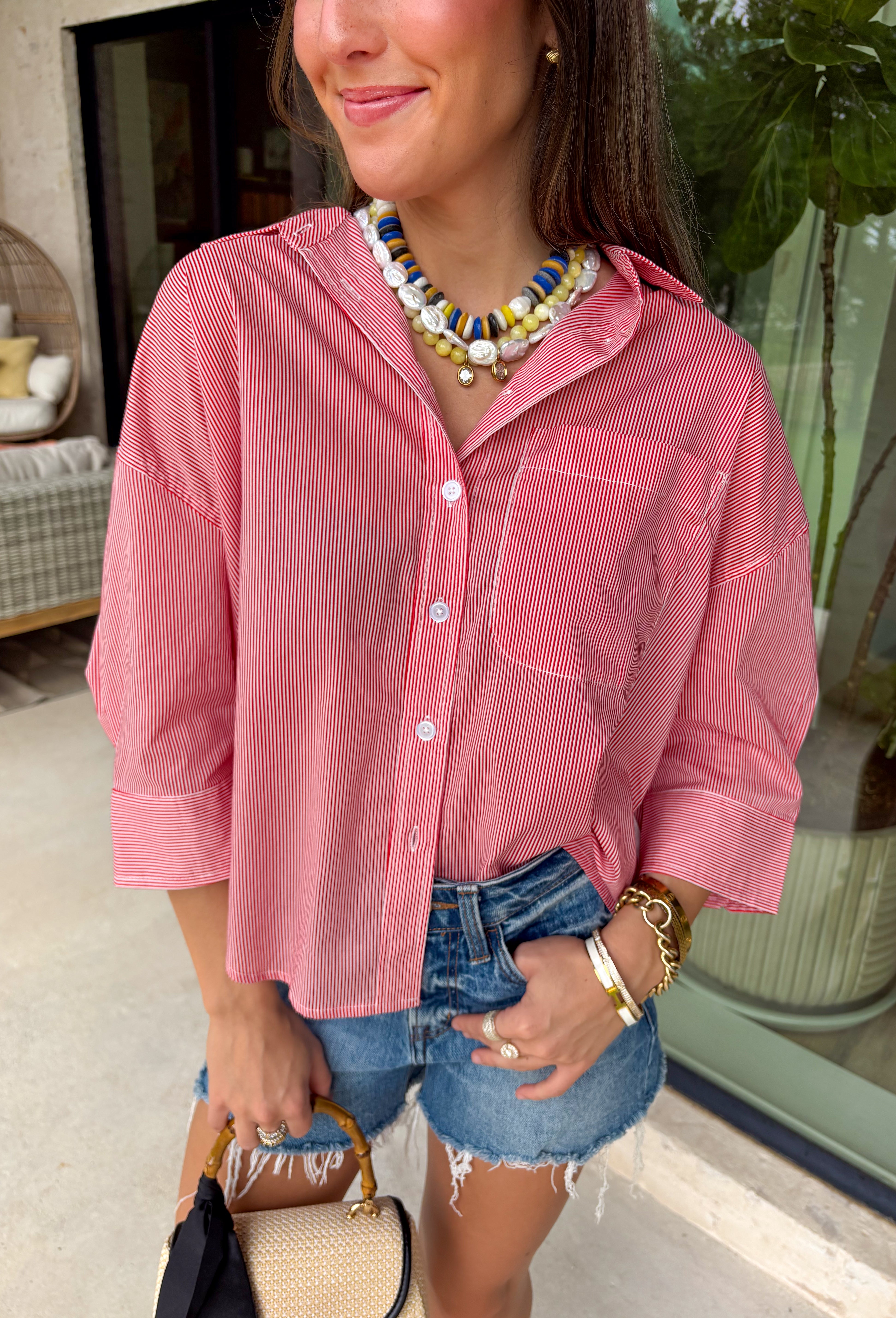 This red and white stripe button down top is a summer classic with a patriotic twist! The timeless stripe print makes it easy to style, while the white stripe detail along the back adds an unexpected touch that sets it apart. Designed with a collared neckline, front pocket, and easy button down silhouette, it’s the perfect piece for everything from backyard BBQs to fireworks and holiday weekends. Made from breathable cotton, it’s lightweight, comfortable, and ready for all your summer plans. 