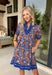 This royal blue floral dress is basically a walking burst of spring happiness! The colorful print is full of bright orange, pink, and green blooms that pop beautifully against the bold blue background, and the scalloped embroidered trim down the front adds the sweetest little detail that makes it feel extra special. Fully lined for easy wear and finished with side pockets.