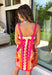 Bring on the sunshine in this vibrant floral dress! Designed with a neutral backdrop and a bold abstract floral print in shades of red, orange, pink, with pops of green and black, this dress is made to stand out all summer long. The pink rickrack trim along the front and hem adds a playful, vintage-inspired touch, while the adjustable straps and elastic back create a comfortable, flattering fit. 