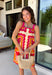 Bring on the sunshine in this vibrant floral dress! Designed with a neutral backdrop and a bold abstract floral print in shades of red, orange, pink, with pops of green and black, this dress is made to stand out all summer long. The pink rickrack trim along the front and hem adds a playful, vintage-inspired touch, while the adjustable straps and elastic back create a comfortable, flattering fit. 
