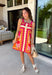 Bring on the sunshine in this vibrant floral dress! Designed with a neutral backdrop and a bold abstract floral print in shades of red, orange, pink, with pops of green and black, this dress is made to stand out all summer long. The pink rickrack trim along the front and hem adds a playful, vintage-inspired touch, while the adjustable straps and elastic back create a comfortable, flattering fit. 