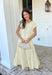 This yellow and white stripe two piece set is bringing all the sunshine to your warm weather wardrobe! The short sleeve top features cuffed sleeves and a subtle keyhole closure for a polished touch, while the matching tiered midi skirt with an elastic waistband keeps things comfortable and flattering. Made from breathable 100% cotton, this set is perfect for warm days filled with brunch plans, baby showers, or weekend outings. 