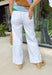 These white wide leg jeans are the ultimate summer staple with a flattering twist! Designed with built-in tummy control, they give you that smooth, confident fit while still feeling comfortable all day long. The classic wide leg silhouette with a clean, wide hem keeps the look timeless and easy to style for any occasion. With just the right amount of stretch, they move with you while holding their shape. 