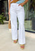 These white wide leg jeans are the ultimate summer staple with a flattering twist! Designed with built-in tummy control, they give you that smooth, confident fit while still feeling comfortable all day long. The classic wide leg silhouette with a clean, wide hem keeps the look timeless and easy to style for any occasion. With just the right amount of stretch, they move with you while holding their shape. 