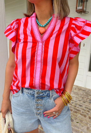 This pink and red striped flutter sleeve top is bringing all the bright, happy summer energy! The bold stripe combo feels fun and fresh, while the flutter sleeves add that soft, feminine touch that’s easy to dress up or down. The stripe trim along the v-neck gives it a unique, elevated detail that makes this one stand out from your everyday tops. Lightweight and breathable in 100% cotton, it’s perfect for warm days when you still want to feel put together.