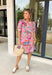 Bright, cheerful, and made for sunny days, this pink short sleeve dress by Umgee is bursting with springtime charm. Featuring a playful mix of floral and paisley prints with pops of green, orange, blue, purple, and white, this dress is a true statement piece. The pink and white banded sleeves and neckline add a fun, sporty touch that keeps the look fresh and effortless—perfect for everything from weekend plans to spring gatherings.
