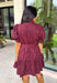 Rich in color and timeless in style, this burgundy dress is the perfect piece to carry you through the fall season. Designed with a classic button-front silhouette, this effortlessly feminine dress features charming puff sleeves and a matching self-tie belt that cinches the waist for a flattering, customizable fit. Side pockets add everyday functionality, while the fully lined cotton fabric keeps you comfortable from morning to night. 