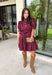 Rich in color and timeless in style, this burgundy dress is the perfect piece to carry you through the fall season. Designed with a classic button-front silhouette, this effortlessly feminine dress features charming puff sleeves and a matching self-tie belt that cinches the waist for a flattering, customizable fit. Side pockets add everyday functionality, while the fully lined cotton fabric keeps you comfortable from morning to night. 