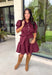 Rich in color and timeless in style, this burgundy dress is the perfect piece to carry you through the fall season. Designed with a classic button-front silhouette, this effortlessly feminine dress features charming puff sleeves and a matching self-tie belt that cinches the waist for a flattering, customizable fit. Side pockets add everyday functionality, while the fully lined cotton fabric keeps you comfortable from morning to night. 