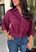 Every wardrobe needs a timeless wine blouse, and this versatile top from Entro is one you'll reach for again and again. Designed with a flattering v-neckline and button-front closure, this effortlessly polished piece transitions seamlessly from workdays to weekends. The ¾ roll-tab sleeves offer versatile styling, while the elasticized smocked back hem creates a comfortable fit with a modern touch. 