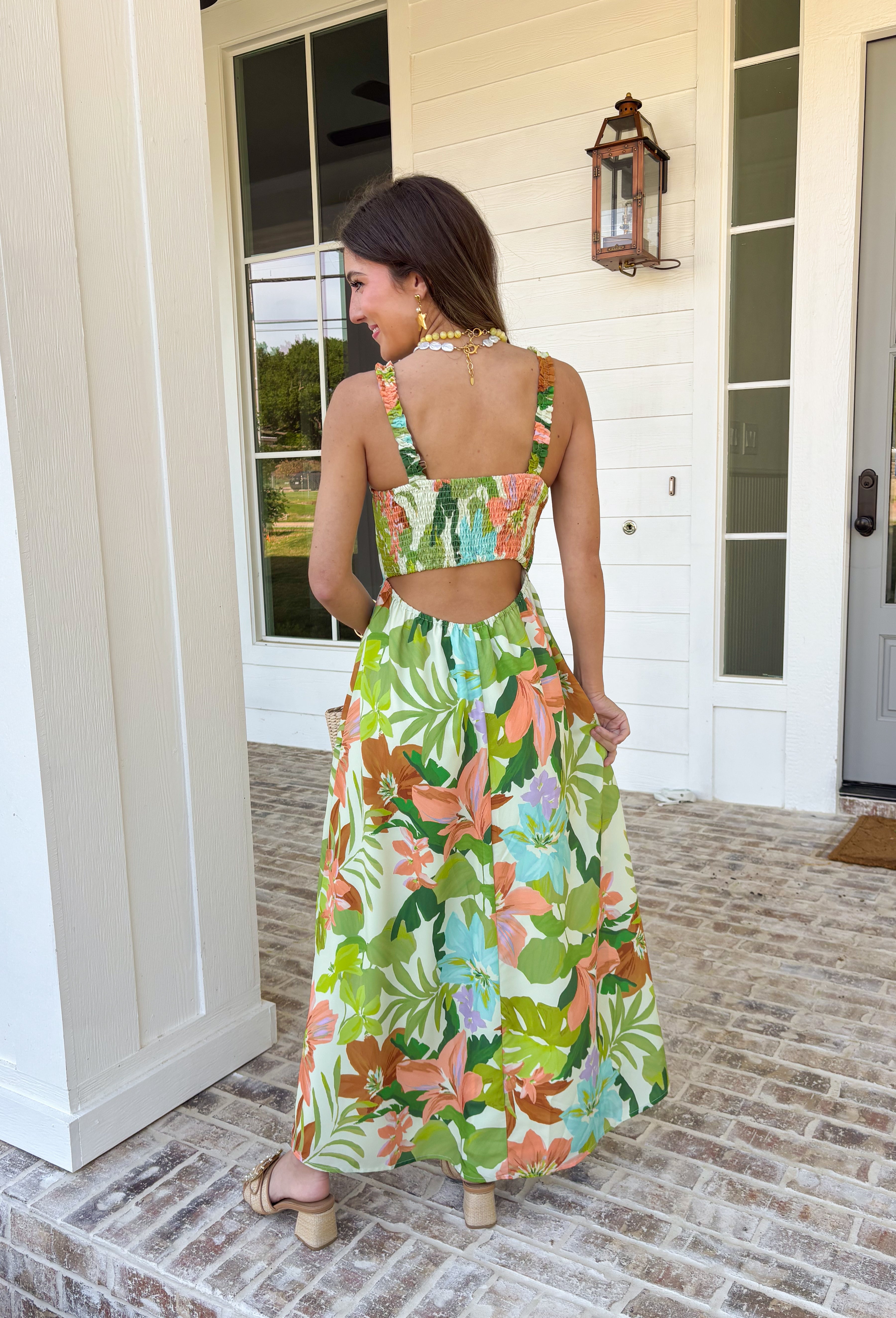 Vacation vibes in dress form! This green sleeveless midi dress features a vibrant tropical print in shades of green, tan, and blue with subtle pops of purple for the prettiest, eye-catching mix. It’s bold, breezy, and perfect for sunny days and warm nights. Designed with a flattering v-neckline and an open back for a little added wow factor, this dress also features smocked straps and a smocked back for a comfortable, flexible fit. Fully lined and lightweight.