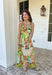 Vacation vibes in dress form! This green sleeveless midi dress features a vibrant tropical print in shades of green, tan, and blue with subtle pops of purple for the prettiest, eye-catching mix. It’s bold, breezy, and perfect for sunny days and warm nights. Designed with a flattering v-neckline and an open back for a little added wow factor, this dress also features smocked straps and a smocked back for a comfortable, flexible fit. Fully lined and lightweight.