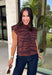 Bring a bold touch to your fall wardrobe with this effortlessly chic knit sweater. The camel and black zebra print offers a fresh take on animal print, while the mock neckline and sleeveless silhouette make it perfect for layering under jackets and cardigans or wearing on its own during those warm autumn afternoons. Soft, comfortable, and endlessly versatile, this is a piece you'll reach for again and again all season long.
