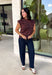 Bring a bold touch to your fall wardrobe with this effortlessly chic knit sweater. The camel and black zebra print offers a fresh take on animal print, while the mock neckline and sleeveless silhouette make it perfect for layering under jackets and cardigans or wearing on its own during those warm autumn afternoons. Soft, comfortable, and endlessly versatile, this is a piece you'll reach for again and again all season long.