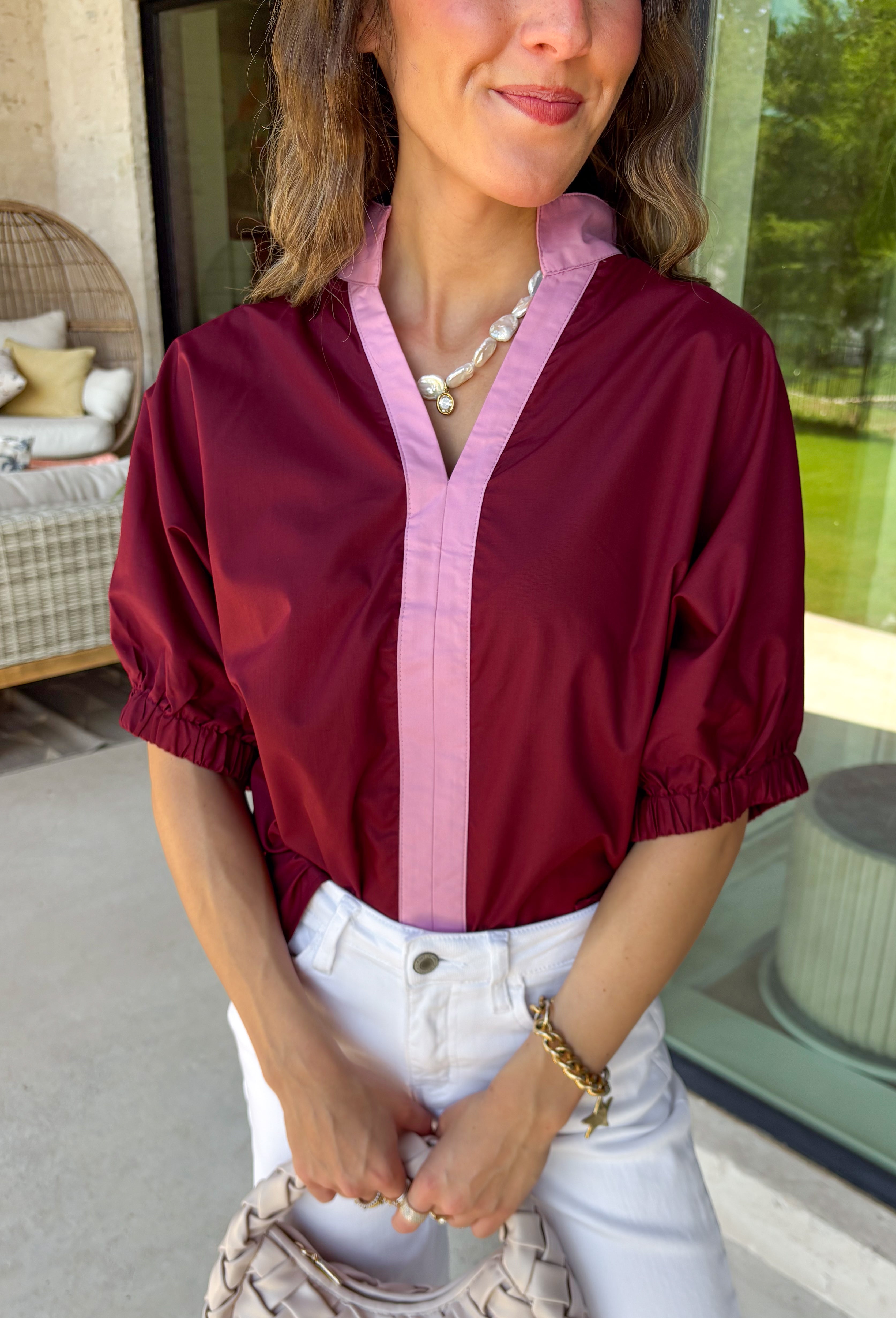 Rich fall colors and timeless details make this burgundy top an instant wardrobe favorite! The deep burgundy hue is beautifully accented with a pink trim along the neckline and front, creating a subtle pop of color that feels both feminine and sophisticated. The elastic puff sleeves add just the right amount of volume, giving this top an elevated look that's perfect for workdays, dinner dates, or weekend outings. Comfortable and easy to style, it's the kind of piece you'll reach for all season long.