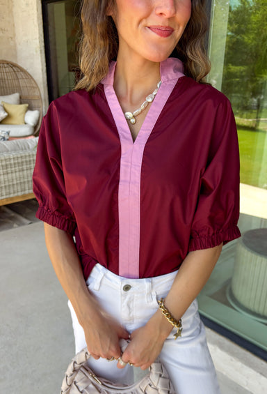 Rich fall colors and timeless details make this burgundy top an instant wardrobe favorite! The deep burgundy hue is beautifully accented with a pink trim along the neckline and front, creating a subtle pop of color that feels both feminine and sophisticated. The elastic puff sleeves add just the right amount of volume, giving this top an elevated look that's perfect for workdays, dinner dates, or weekend outings. Comfortable and easy to style, it's the kind of piece you'll reach for all season long.