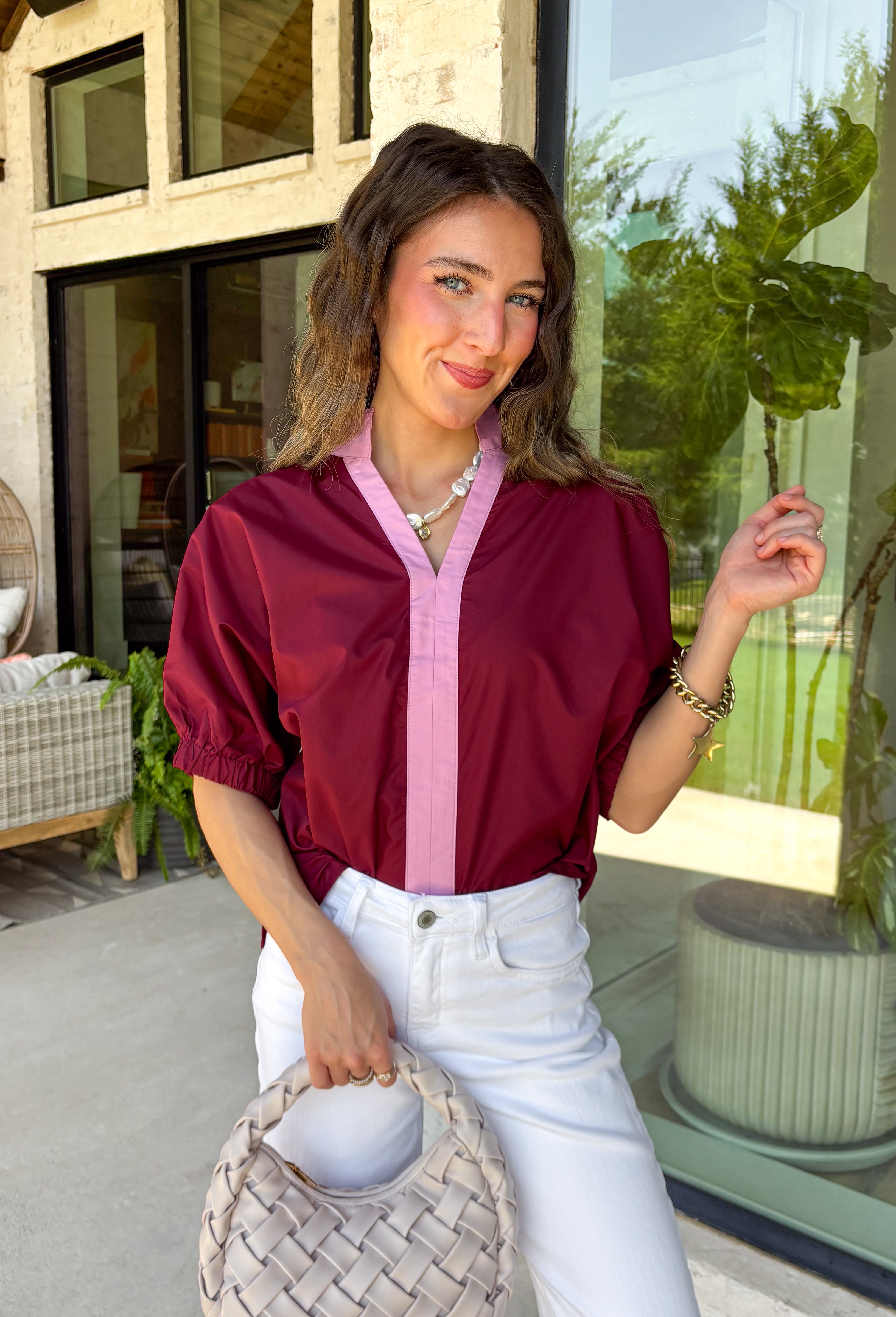 Rich fall colors and timeless details make this burgundy top an instant wardrobe favorite! The deep burgundy hue is beautifully accented with a pink trim along the neckline and front, creating a subtle pop of color that feels both feminine and sophisticated. The elastic puff sleeves add just the right amount of volume, giving this top an elevated look that's perfect for workdays, dinner dates, or weekend outings. Comfortable and easy to style, it's the kind of piece you'll reach for all season long.