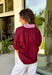 Rich fall colors and timeless details make this burgundy top an instant wardrobe favorite! The deep burgundy hue is beautifully accented with a pink trim along the neckline and front, creating a subtle pop of color that feels both feminine and sophisticated. The elastic puff sleeves add just the right amount of volume, giving this top an elevated look that's perfect for workdays, dinner dates, or weekend outings. Comfortable and easy to style, it's the kind of piece you'll reach for all season long.