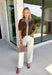 Rich fall colors and timeless details make this brown top an instant wardrobe favorite! The rich brown hue is beautifully accented with a blue trim along the neckline and front, creating a subtle pop of color that feels both feminine and sophisticated. The elastic puff sleeves add just the right amount of volume, giving this top an elevated look that's perfect for workdays, dinner dates, or weekend outings. Comfortable and easy to style, it's the kind of piece you'll reach for all season long. 