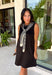 The layered look has never been easier! This black knit mini dress features an attached black and white striped sweater scarf detail, giving you the cozy, elevated style of layered fall fashion in one effortless piece. Crafted from a soft, comfortable knit, it's perfect for crisp autumn days when you want to look polished without sacrificing comfort. From brunch dates and shopping trips to dinner with friends, this chic dress is ready for every fall occasion.