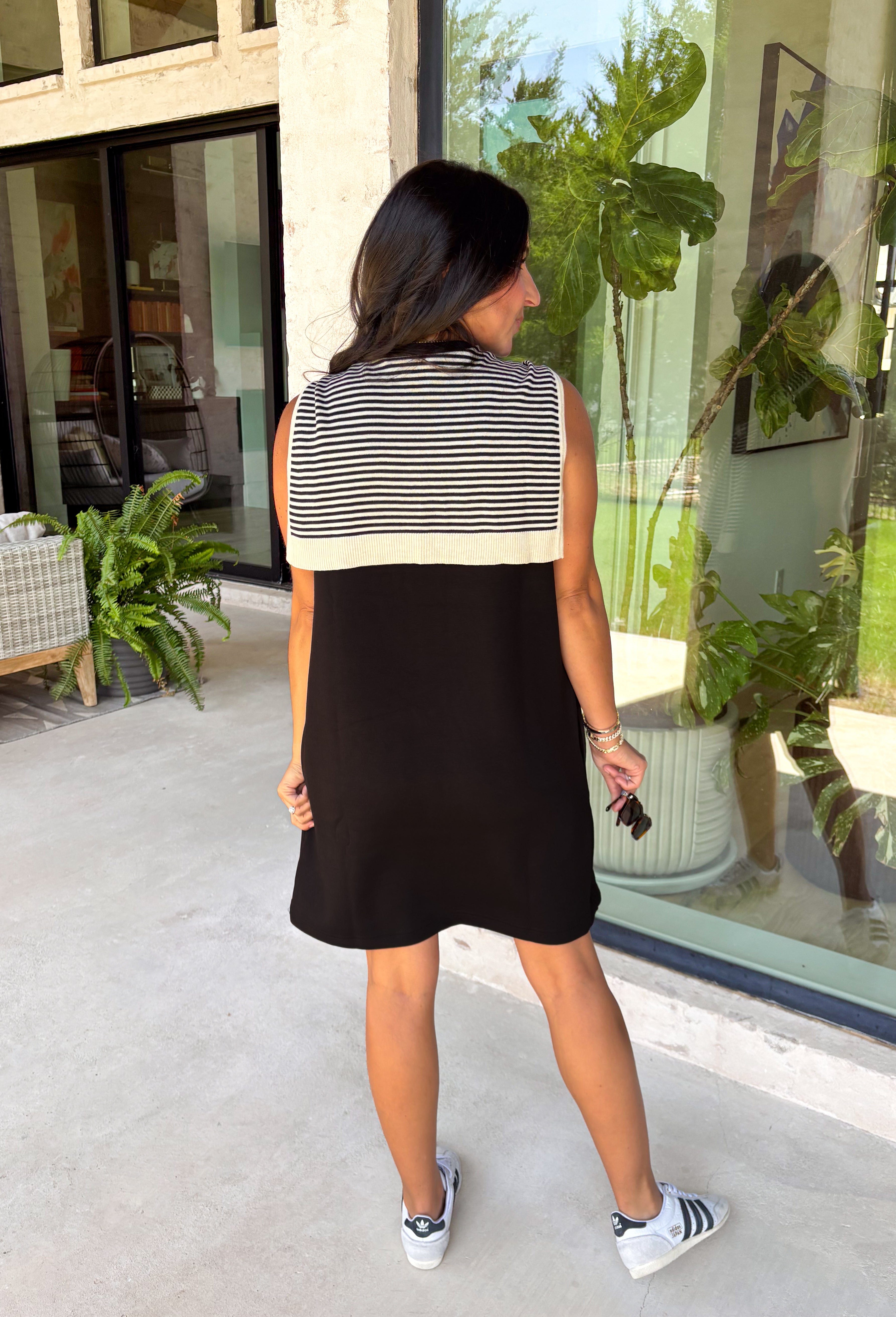 The layered look has never been easier! This black knit mini dress features an attached black and white striped sweater scarf detail, giving you the cozy, elevated style of layered fall fashion in one effortless piece. Crafted from a soft, comfortable knit, it's perfect for crisp autumn days when you want to look polished without sacrificing comfort. From brunch dates and shopping trips to dinner with friends, this chic dress is ready for every fall occasion.