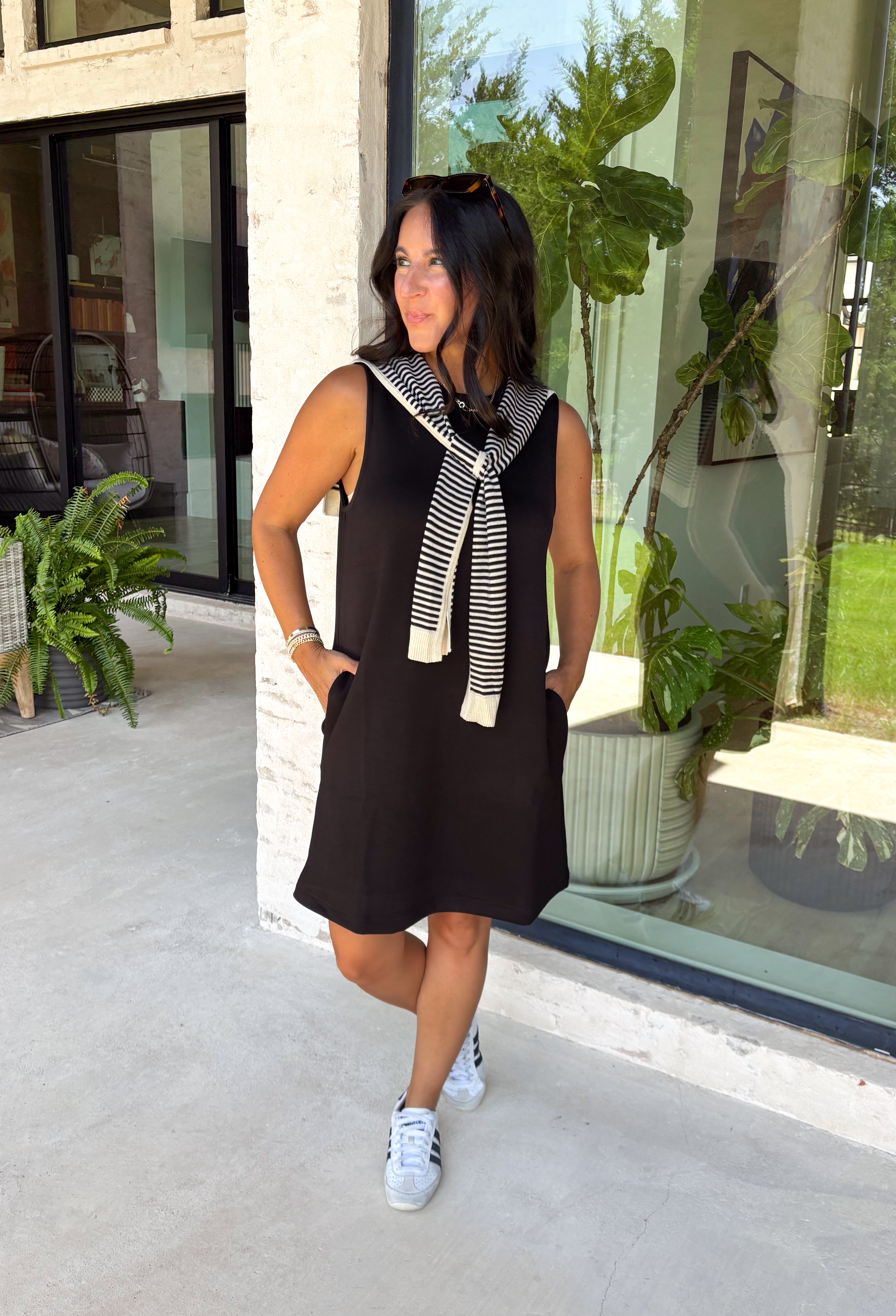The layered look has never been easier! This black knit mini dress features an attached black and white striped sweater scarf detail, giving you the cozy, elevated style of layered fall fashion in one effortless piece. Crafted from a soft, comfortable knit, it's perfect for crisp autumn days when you want to look polished without sacrificing comfort. From brunch dates and shopping trips to dinner with friends, this chic dress is ready for every fall occasion.