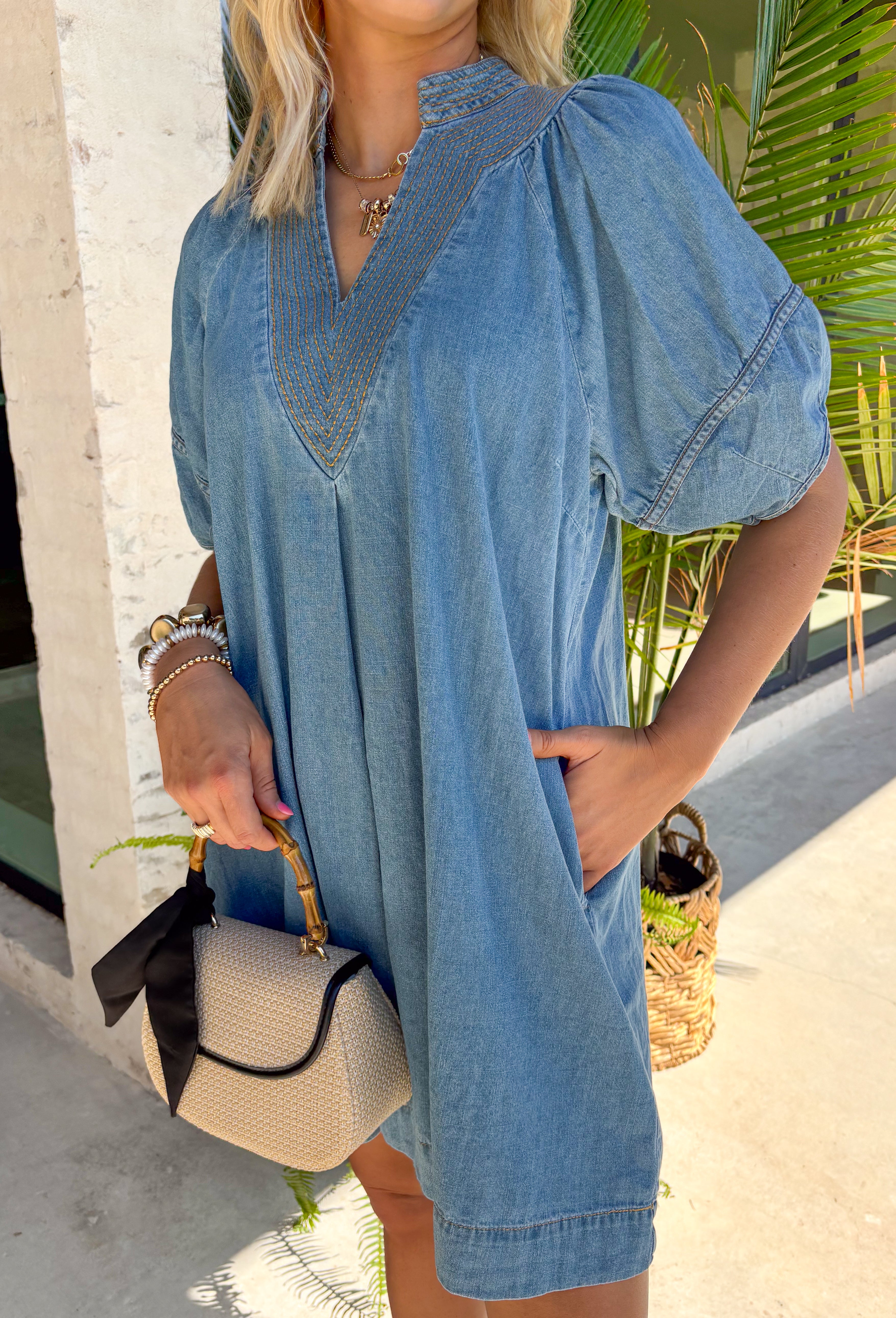 This medium wash denim dress is the kind of effortless staple you’ll reach for all summer long! The tan stitching detail along the front adds just the right amount of contrast, giving it a subtle, elevated touch. Designed with a flattering v-neckline and easy silhouette, it’s both comfortable and polished for everyday wear. And yes—side pockets make it even better! Lightweight with a soft feel, it’s perfect for everything from errands to casual dinners. 