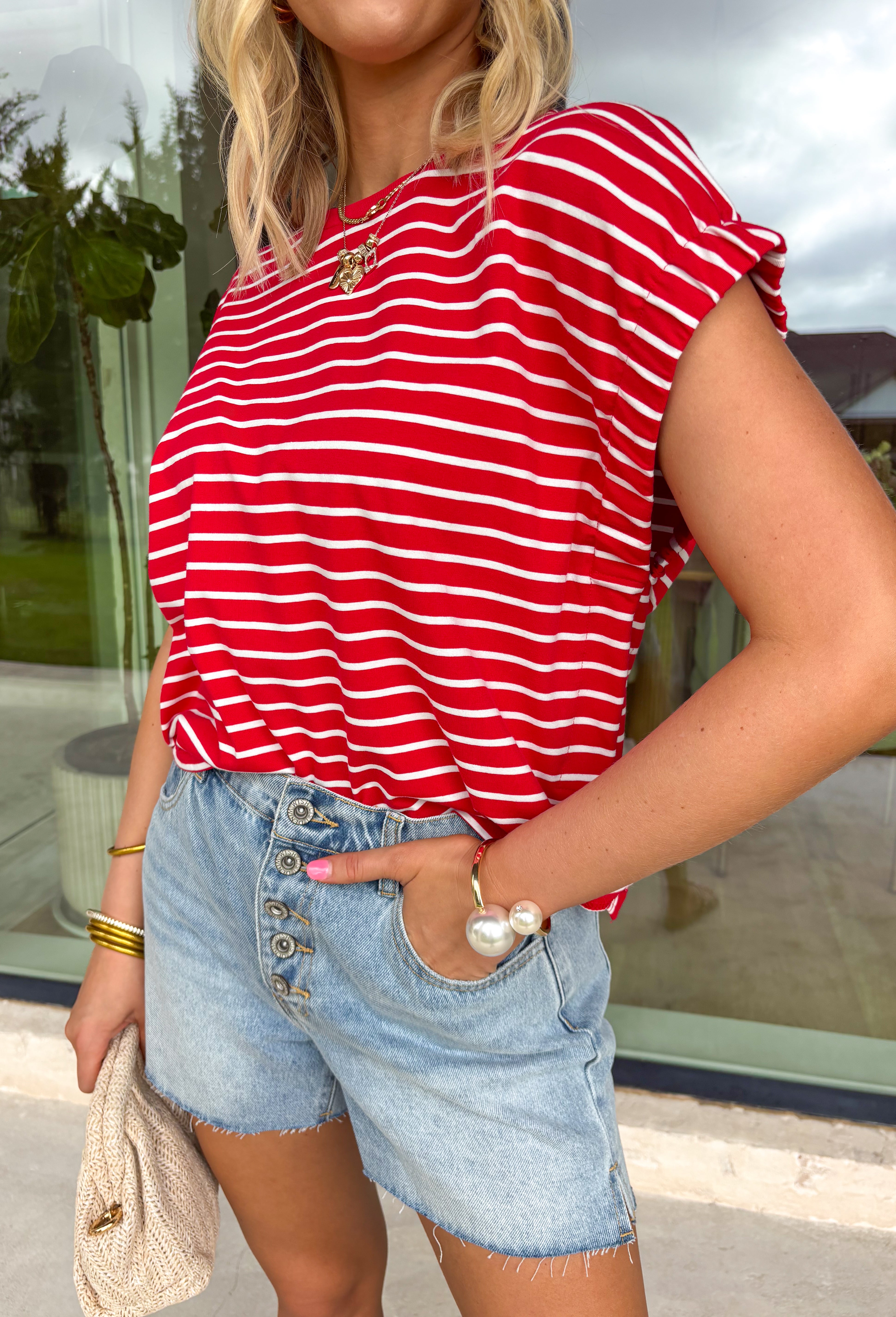 Nothing says “easy spring outfit” like a classic red-and-white stripe moment! This short sleeve top is one of those throw-on-and-go pieces that instantly looks cute without even trying. The bright red base feels fun and fresh for the season, while the crisp white stripes keep it timeless. Finished with elastic sleeve cuffs for a soft, slightly puffed shape, it’s comfy enough for all-day wear and polished enough to dress up with your favorite denim and accessories.
