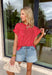 Nothing says “easy spring outfit” like a classic red-and-white stripe moment! This short sleeve top is one of those throw-on-and-go pieces that instantly looks cute without even trying. The bright red base feels fun and fresh for the season, while the crisp white stripes keep it timeless. Finished with elastic sleeve cuffs for a soft, slightly puffed shape, it’s comfy enough for all-day wear and polished enough to dress up with your favorite denim and accessories.